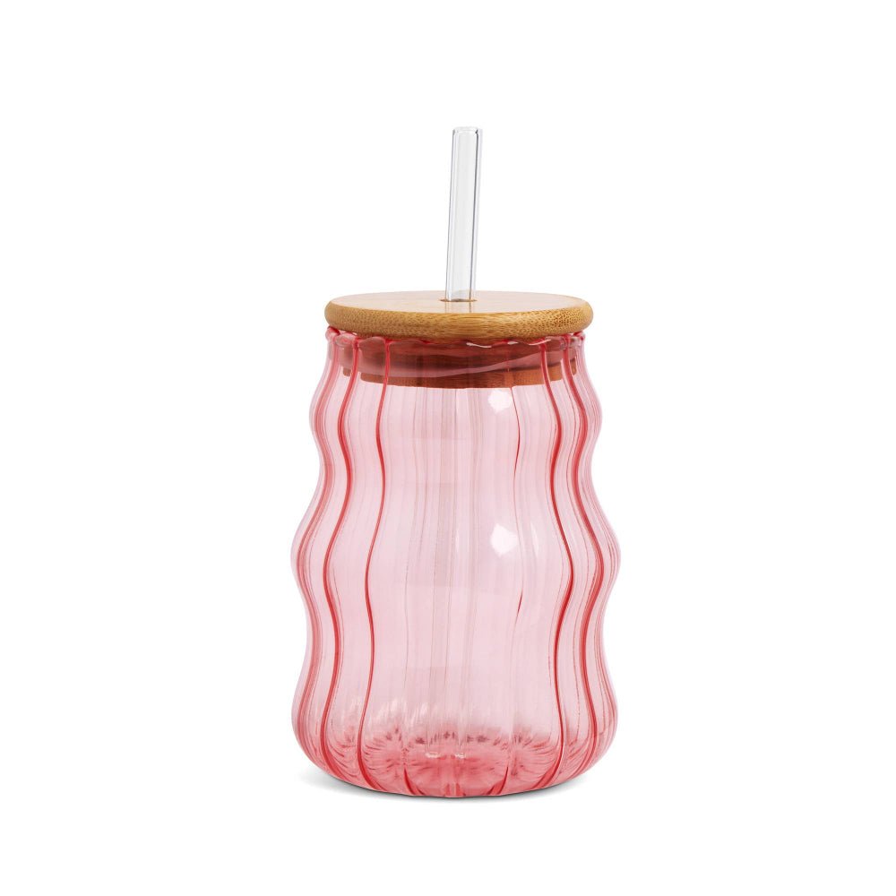 Pink glass tumbler with a wooden lid and straw on a white background